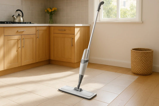 Spray mop system standing upright on a clean light-colored ceramic tile kitchen floor with visible grout lines in a bright kitchen
